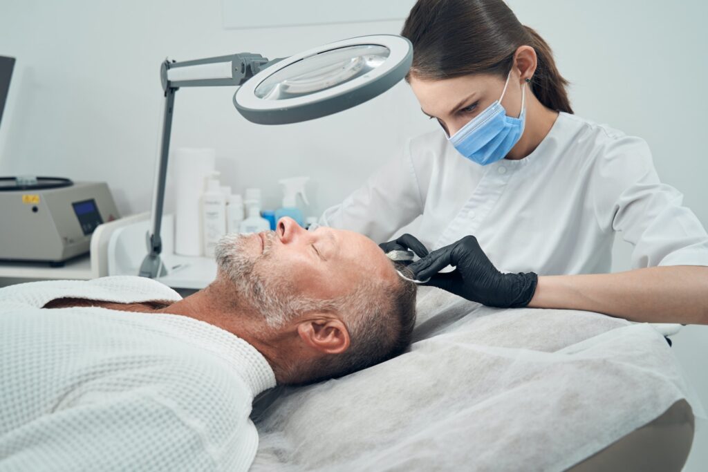 Man getting injection for hair growth in cosmetology clinic